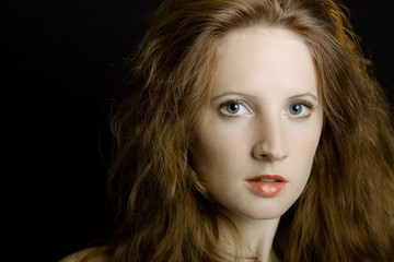 Fototapeta premium The young beautiful girl with freckles