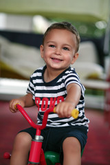 Fototapeta na wymiar Little boy on a tricycle
