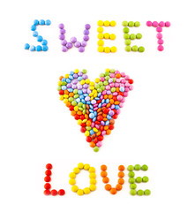 Inscription love from multi coloured chocolate candy