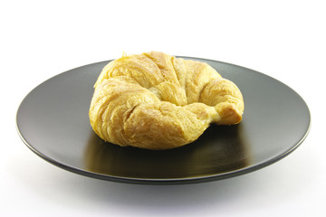 Croissant on a Black Plate