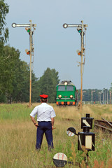 Railway traffic controller giving a signals to the train crew