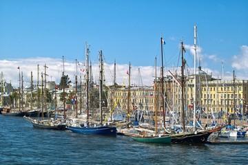 Tallships and yachts in front of antique buildings