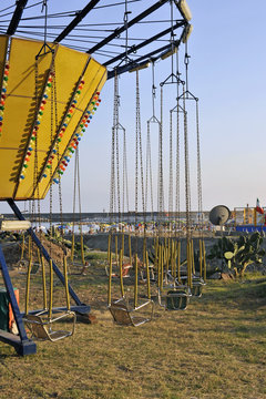 Detail of carousel on a summer playground next to the beach
