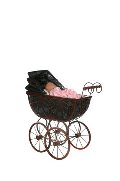 antique baby carriage against high key background