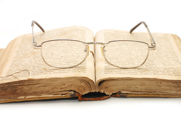 old book and glasses on it