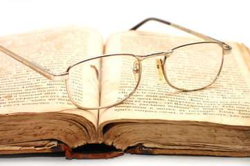 old book and glasses on it