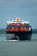 fully loaded container ship head-on