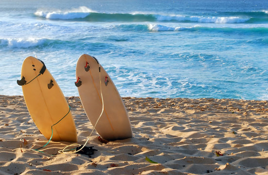 Hawaiian beach with 2 surfboards in the sand