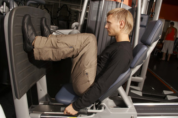 a male bodybuilder working out in gym