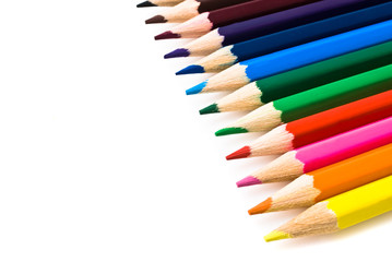 Assortment of coloured pencils with shadow on white background