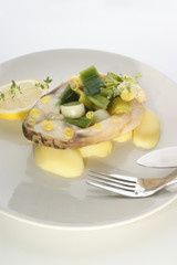 cooked carp fillet on organic potato organic vegetable and lemon
