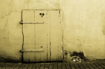 Old door with heart-shaped cutout