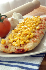 stone oven backed pizza with sweet corn, tomato and garlic