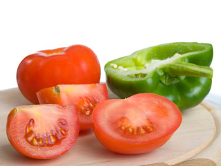 Red tomato and paprika over white background