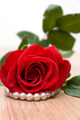 Red Rose and Perls on Wooden Table