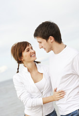 Young couple walking on the beach.