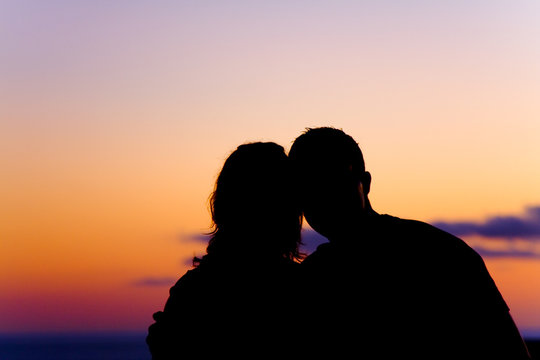 Beautiful silhouette of couple at sunset
