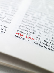 Fototapeta premium The word 'wisdom' highlighted in a dictionary