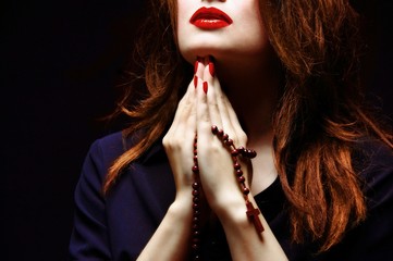 Woman praying with rosary