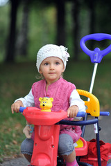 small girl with tricycle