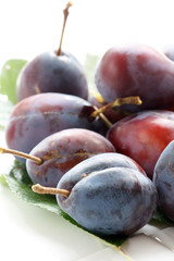Plums on a white background.