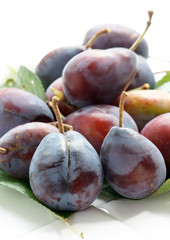 Plums on a white background.