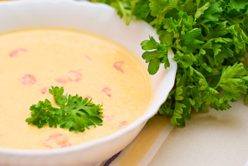 Creamy prawn soup with herbs close up shoot