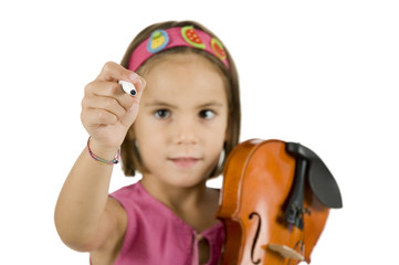 little girl holding a pen and a violin isolated on white