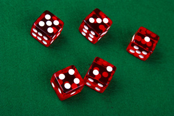 Five dice on a green background