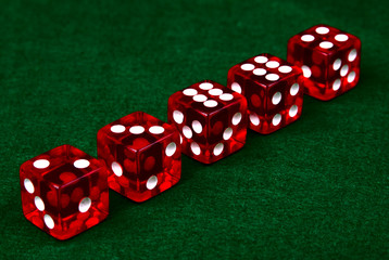Row of dice on green background