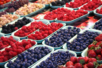 Colorful mix of fresh berries in market.