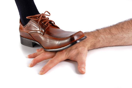 Foot stepping on a hand