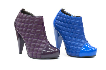 Pair of leather stylish shoes with high heel and decorated with