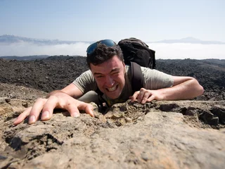 Fotobehang Man climbing a mountain © Stormcab