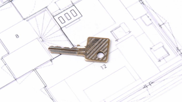 Close-up of plans and keys turning