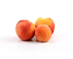 Fototapeta na wymiar Arrangement of three ripe peaches