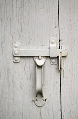 white door handle on a barn
