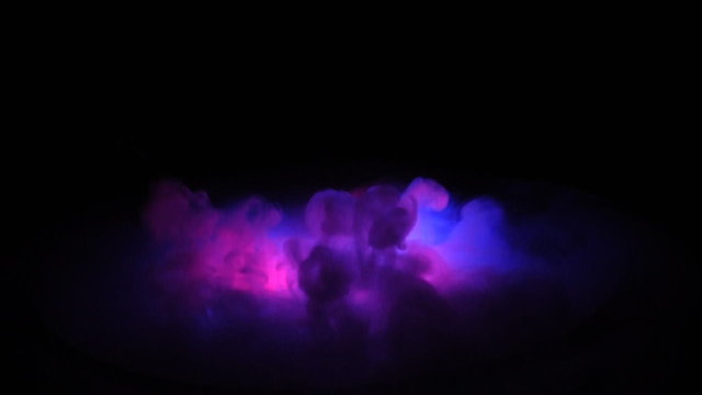 cauldron of boiling dry ice with colored lighting