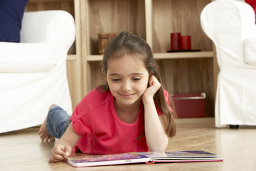 Young Girl Reading Book at Home