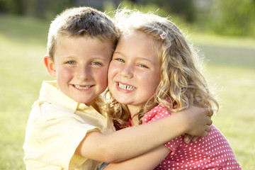 Fototapeta na wymiar 2 Children hugging outdoors