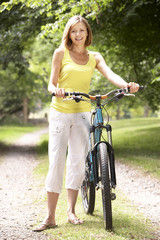 Fototapeta na wymiar Woman riding bike in countryside