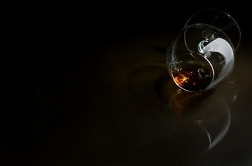 Cognac in the big glass on a dark background