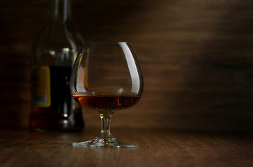 Cognac in the big glass on a dark background