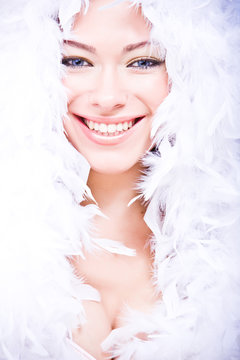 portrait of laughing young woman in white downy boa