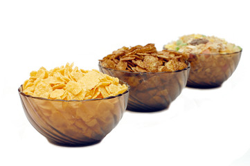 Three cups with different corn flakes