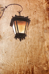 Old lantern on a vintage style  background