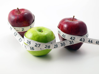 3 Apples surrounded with measuring tape
