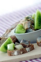 herring salad in a bowl with green tomato