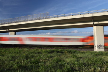 Fototapeta premium Fast train passing under a bridge