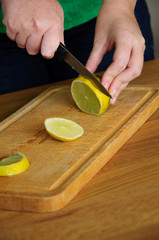 Lemon on cutting board with knife